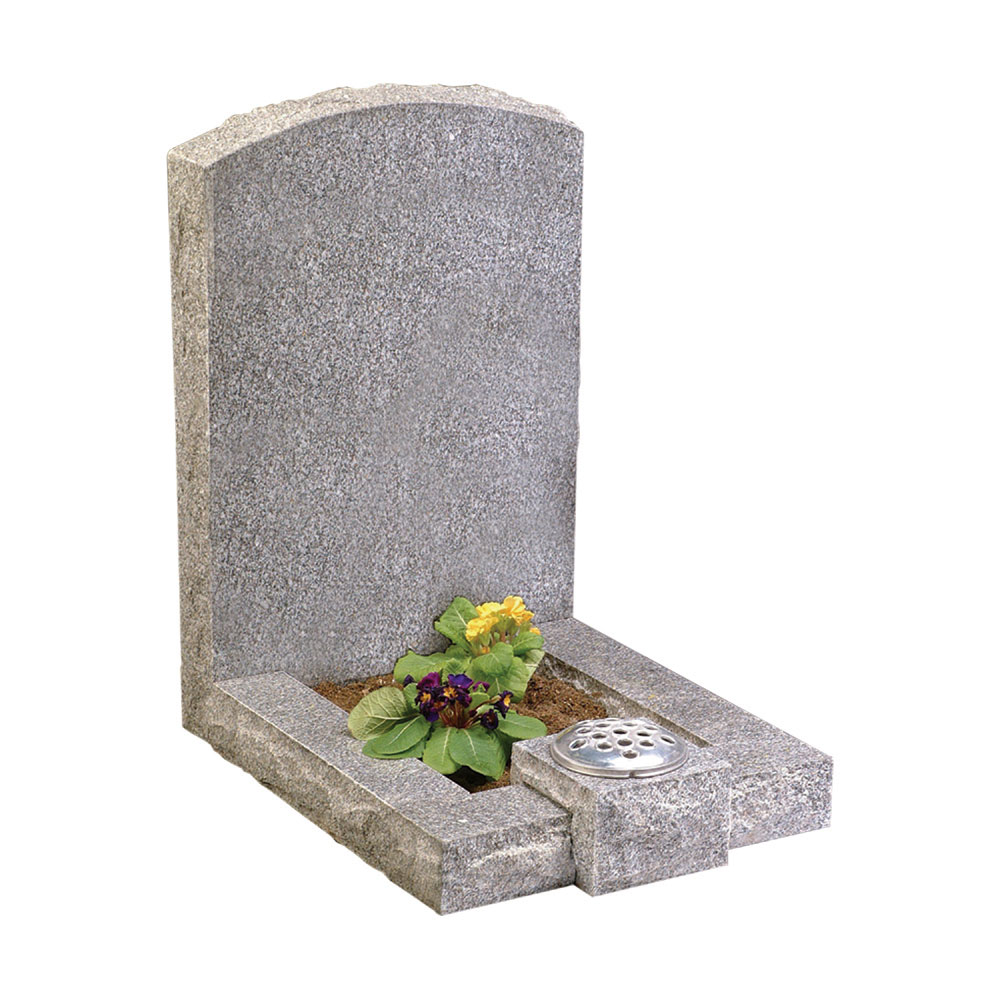 A Traditional Memorial with a yellow flower on top of the grave.